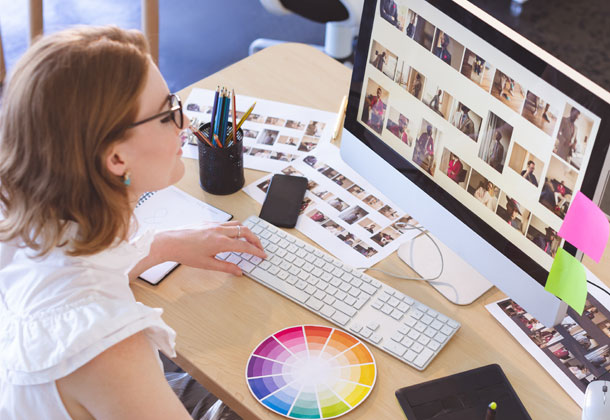 woman using computer with colour wheel on desk