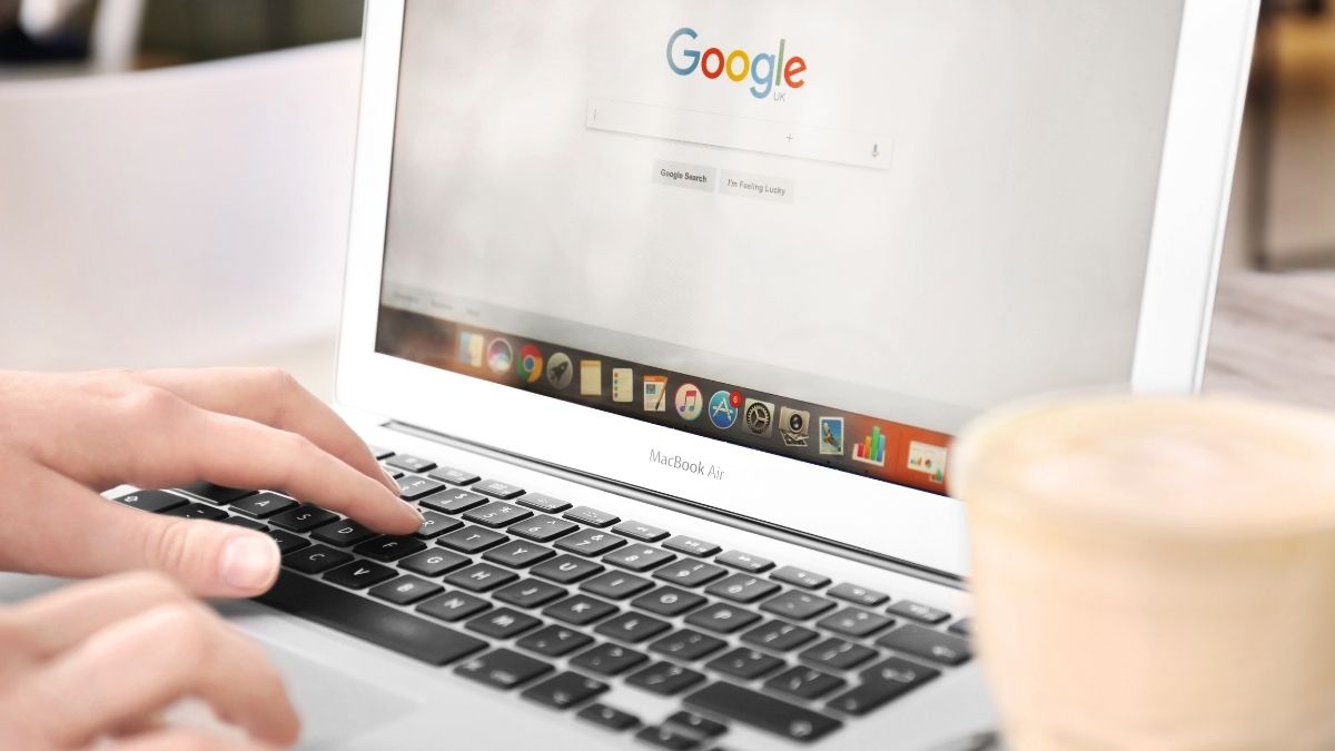 hand on a laptop using google